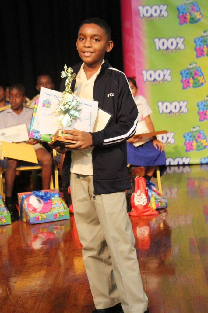 Mikkel Acquart with his prizes and trophy for winning the Kool Kidz Sancom National Spelling Bee at Cipriani College of Labour and Co-operative Studies on June 5. PHOTO BY ENRIQUE ASSOON