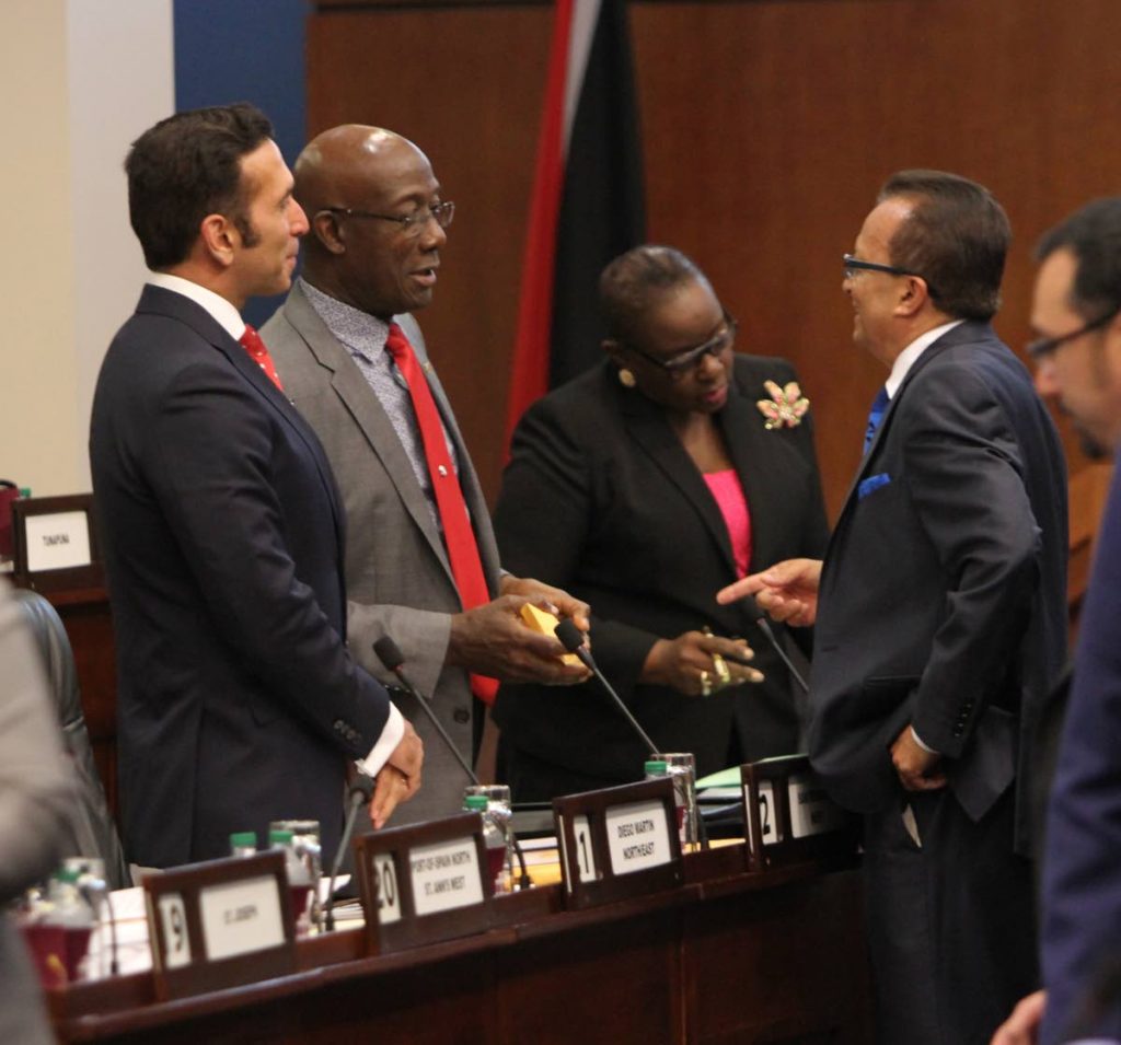 CROSSING THE FLOOR?: Prime Minister Dr Keith Rowley speaks with Chaguanas West MP Ganga Singh during a break in the sitting of Parliament on Wednesday.  Also in photo are Attorney General Faris Al-Rawi (left) and Planning Minister Camille Robinson-Regis. PHOTO BY SUREASH CHOLAI