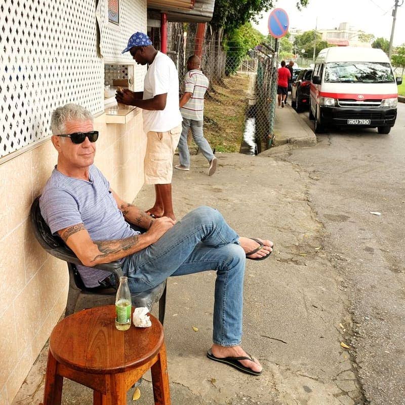 BOURDAIN IN TT: This photo, posted yesterday to the Foodie Nation Facebook page shows internationally renowned chef and CNN food correspondent Anthony Bourdain relaxing outside a doubles shed near the north entrance to UWI in St Augustine during his visit to Trinidad last year. 