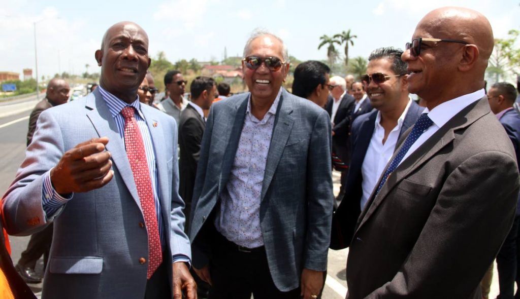 
Time to laugh: Prime Minister Dr Keith Rowley, left, shares a laugh with contractor Junior Sammy, centre, his son Shaun Sammy, second from right, and San Fernando Mayor Junia Regrello, right, at the opening of the section of the Pt Fortin Highway between Bamboo Junction and Mosquito Creek on Friday. PHOTO BY ANSEL JEBODH. 