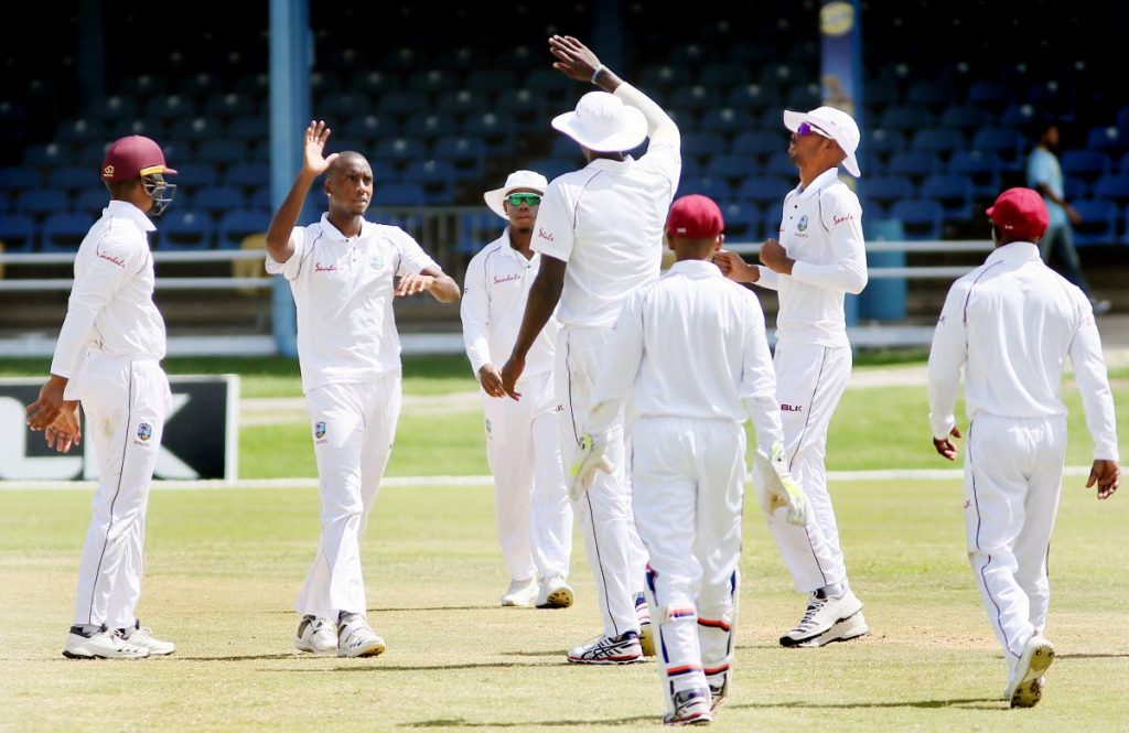 West Indies captain Jason Holder, centre, congratulates pacer Miguel Cummins, second from left, after he took a wicket on day three of the 1st Test vs Sri Lanka at the Queen’s Park Oval, St Clair.