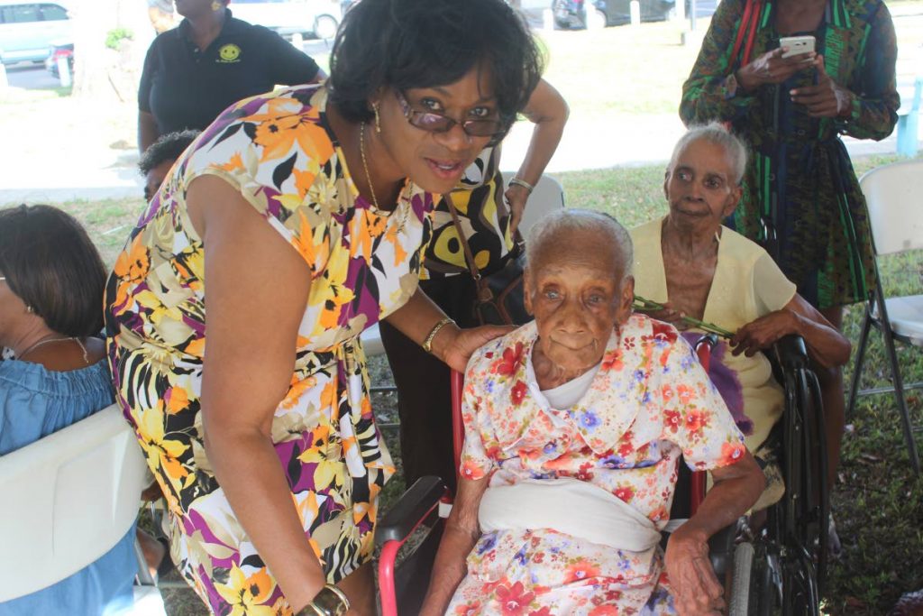 Deputy Commissioner of Police Earla Christopher greets 102-year-old Esther Waldron at Saturday's public discussion on elder abuse hosted by the police service Witness and Victim Support Unit. Photo: Enrique Asson
