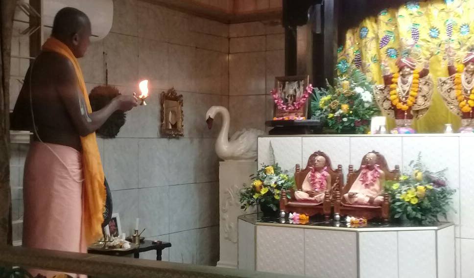 DEVOTION: A devotee worships at the Hare Krishna temple in Longdenville yesterday, hours after bandits broke into the temple, accosted the custodian and stole cash, a stereo system and even gold trinkets which adorned several murtis.