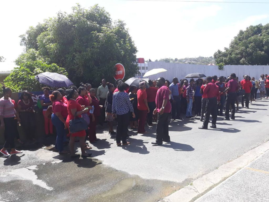 Teachers gather outside the Division of Education at Dutch For Street, Scarborough on Monday to protest lack of action on promoting them from Assistant Teacher 1 positions to Teacher 1.