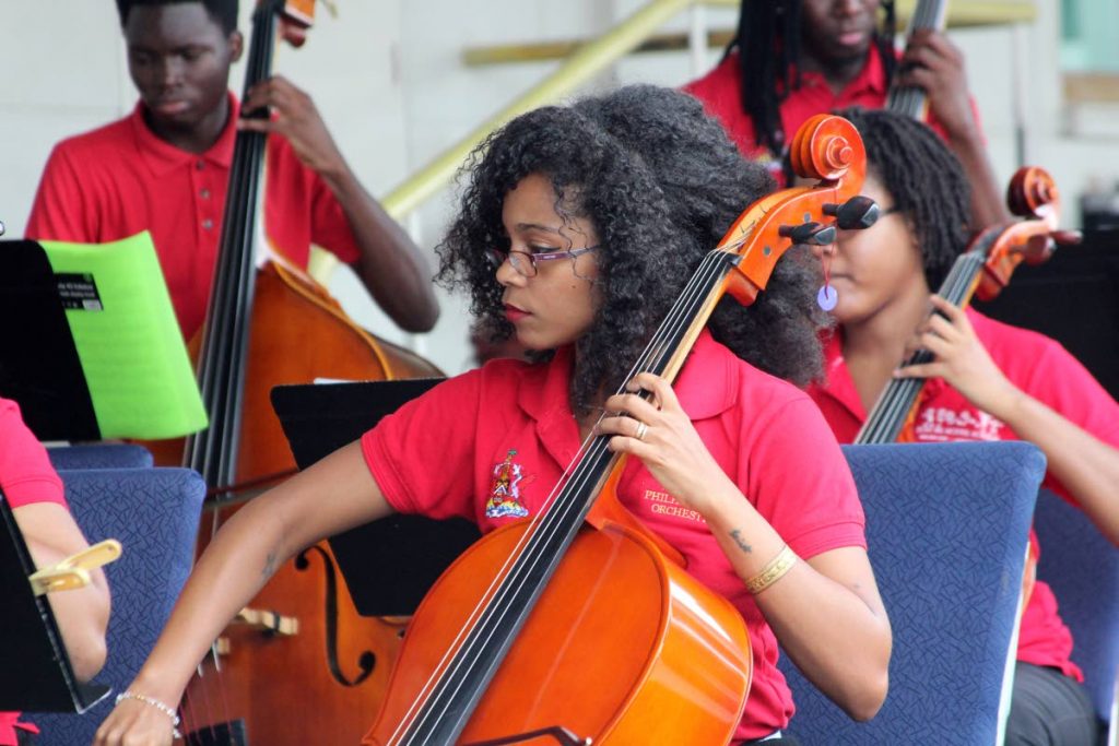 Members of the National Philharmonic Orchestra perform at the National Library,  Abercromby Street, Port of Spain.