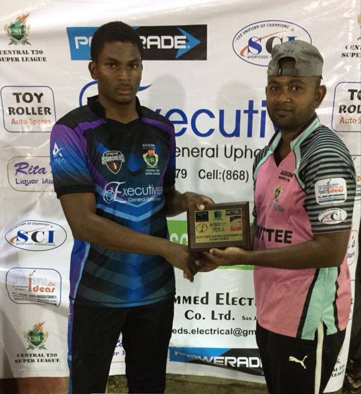 Xtreme Smashers’ Mikel Fredrick, left, collects his Man-of-the-Match award from Kashtri Singh after taking five wickets in the Central Super League.