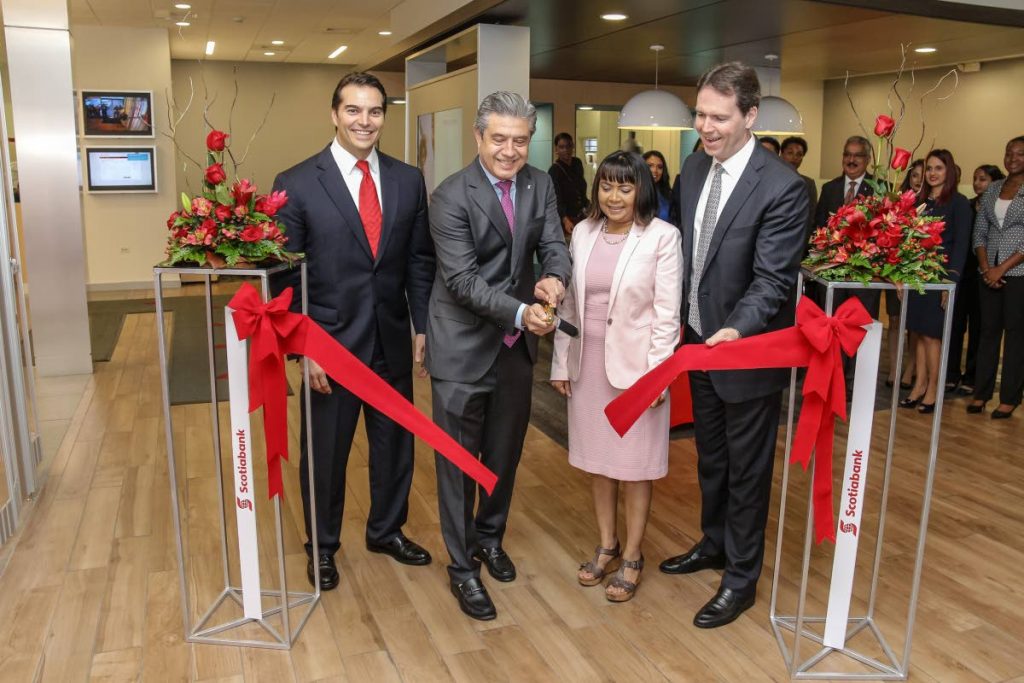 Scotiabank Managing Director Stephen Bagnarol; Ignacio Deschamps Group Head International Banking and Digital Transformation; Dr Sandra Sookram, Deputy Governor of teh Central Bank of TT; and Brendan King Senior VP International Banking cut the ribbon to officially open the bank's digital branch located in Price Plaza, Chaguanas. Photo by Jeff K Mayers