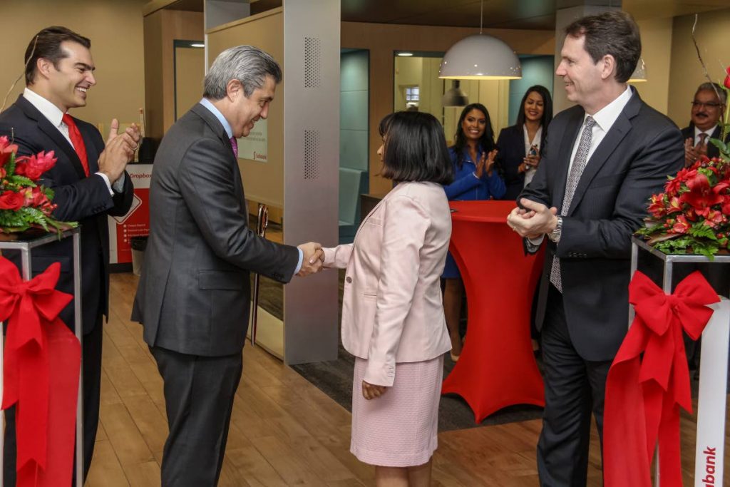 Ignacio Deschamps (second from left), Scotiabank group head international banking and digital transformation shakes hands with Dr Sandra Sookram, deputy governor of the Central Bank, as Scotiabank managing director Stephen Bagnarol (left) and Brendan King, senior vice president international banking look on at the official opening of the bank's digital branch. Photo by Jeff Mayers