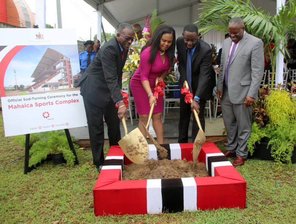 Minister of Sport Shamfa Cudjoe, second from left, turns the sod for the Mahaica Sports Complex with 
Minister of National Security Retired Major Edmond Dillion, left, and Deputy Mayor  Kennedy Richards at Point Fortin yesterday. Looking on at right is CEO of UDECOTT Frank Barnes.