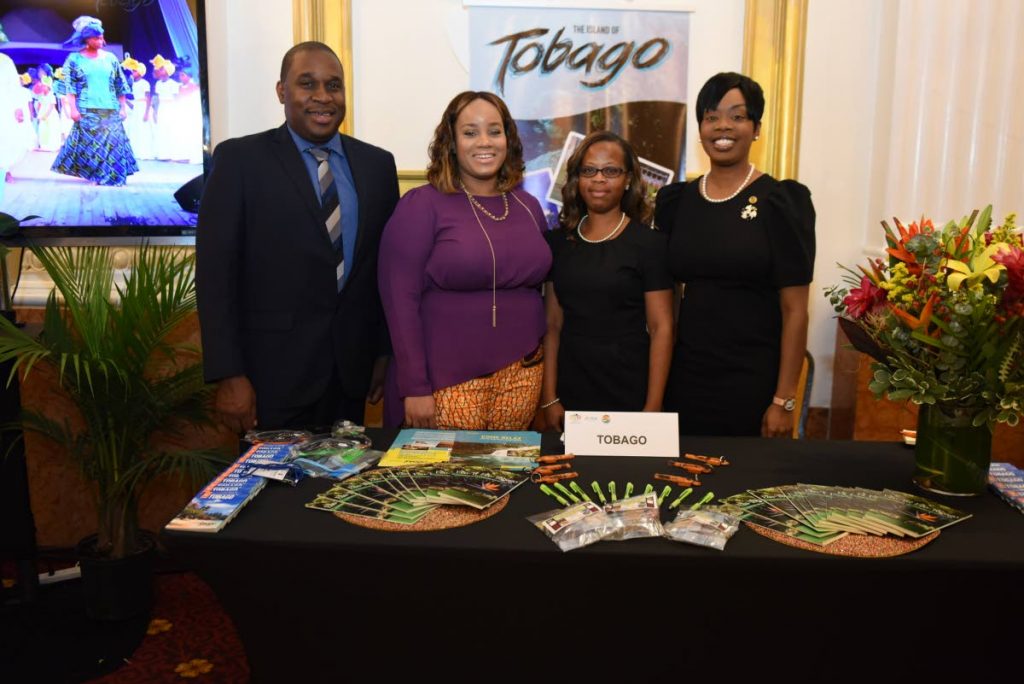 Tourism Secretary Nadine Stewart-Phillips, right, and CEO of the Tobago Tourism Agency (TTA) Louis Lewis, left, pose for a photo with members of the Tobago delegation, Sheena Des Vignes, second from left,  and Denise Doyle-Sebro, at Tobago’s booth at the Trade Show, Educational Forum and Dinner for Travel Agents on June 5 during Caribbean Week, hosted by the Caribbean Tourism Organisation in New York.