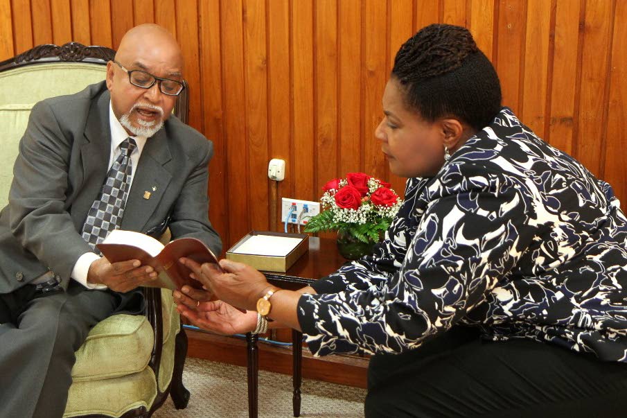 Gideon’s national field co-ordinator Norman Imambaksh presents President Paula-Mae Weekes with a specially embossed Gideon’s Bible at her office in St Ann’s on Tuesday.
