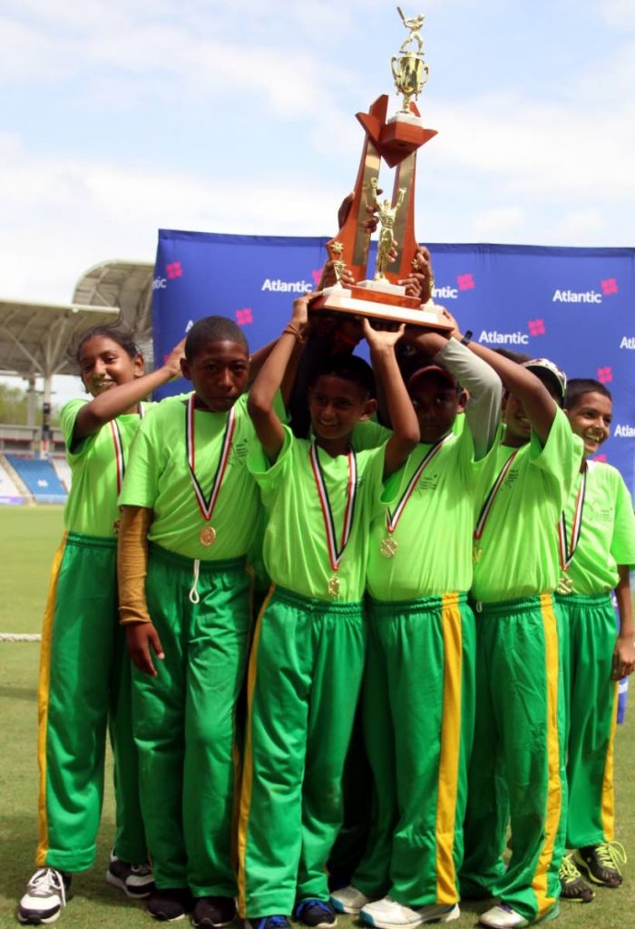 Rio Claro Hindu students lift the trophy after winning the Under-11 Mixed final of the Atlantic National Primary Schools Cricket League on Thursday