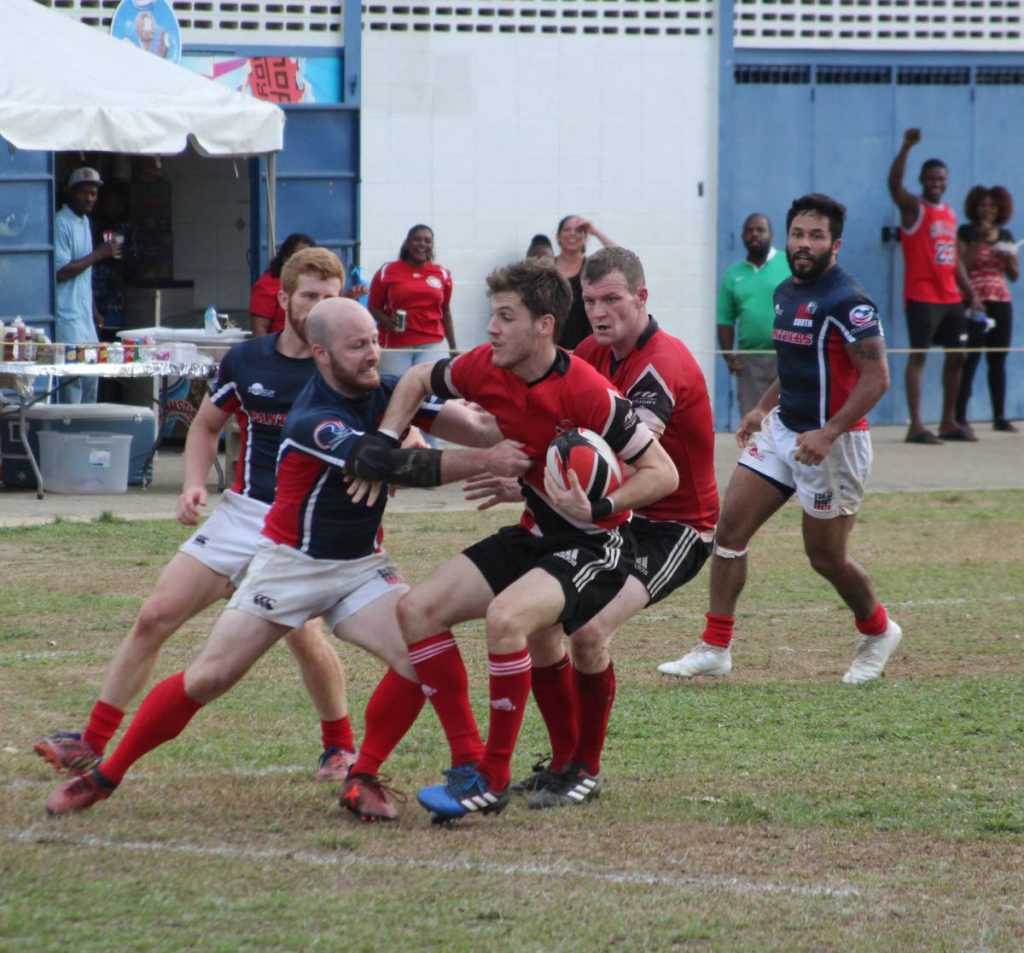 TT’s Sebastian Navarro, third from right, is tackled by a USA South player in their Rugby Americas North (RAN) Men’s 15s clash at St Mary’s Ground, Serpentine Road, St Clair, yesterday. TT came from behind to win 34-33. PHOTO BY ENRIQUE ASSOON
