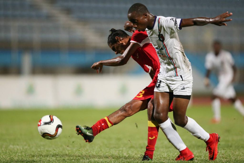 Point Fortin Civic’s Justin Sadoo shoots to score as Morvant Caledonia United’s Jomokie Cassimy, right, defends in their First Citizens Cup clash at the Ato Boldon Stadium, Couva, Saturday.