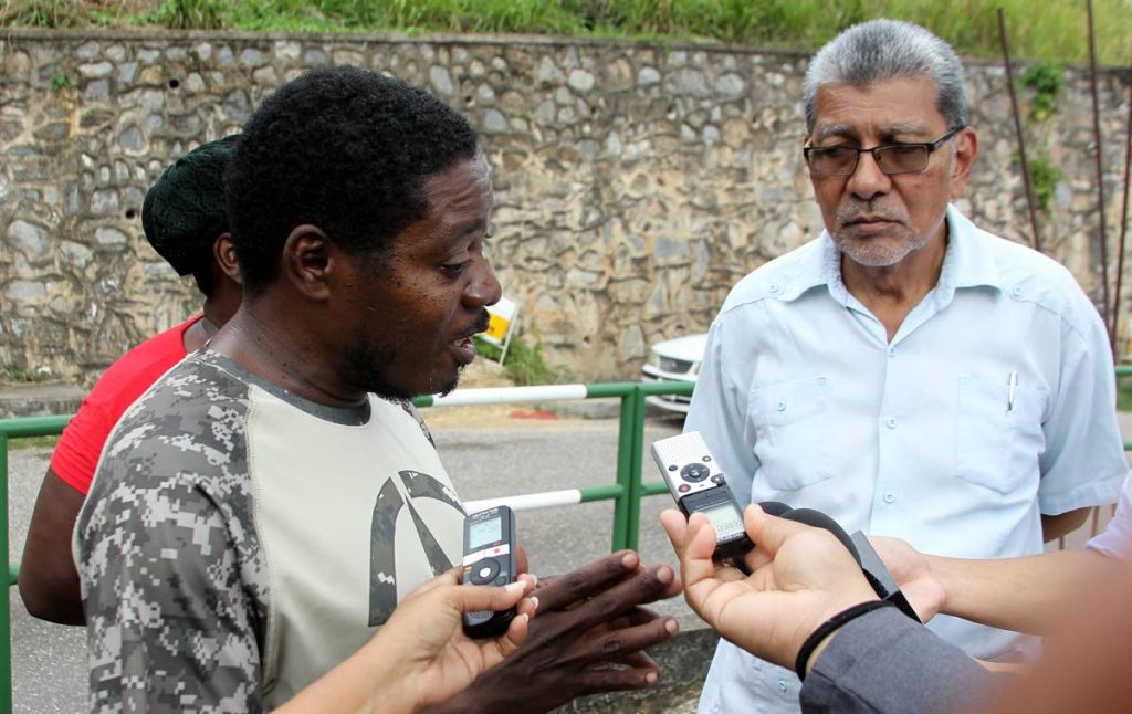 Laventille resident Nigel Cox, speaks to the media on some of the issues in his community. Looking on is MSJ leader David Abdullah. Photo: Angelo Marcelle