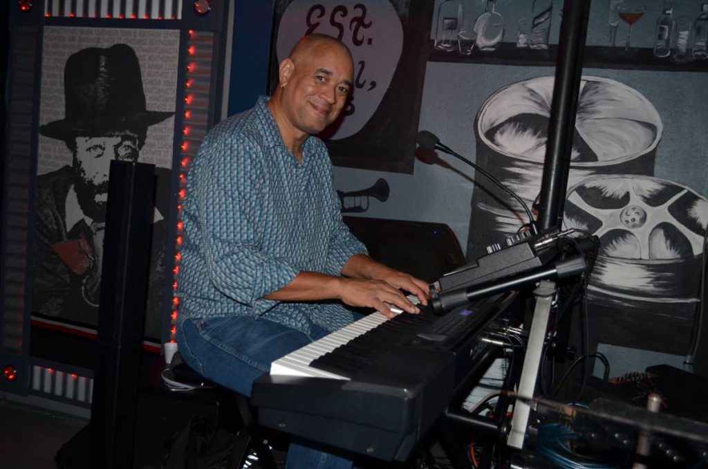  Élan Parlé 's leader Michael 'Ming' Low Chew Tung on his keyboard.