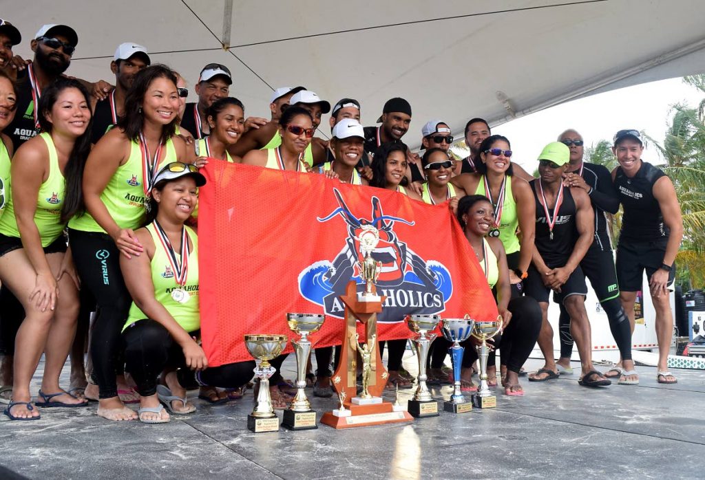 DOMINANT: Aquaholics show off their trophies at the awards ceremony of the Pigeon Point Heritage Park Annual Dragon Boat Festival, at Pigeon Point Beach, Tobago, Sunday.