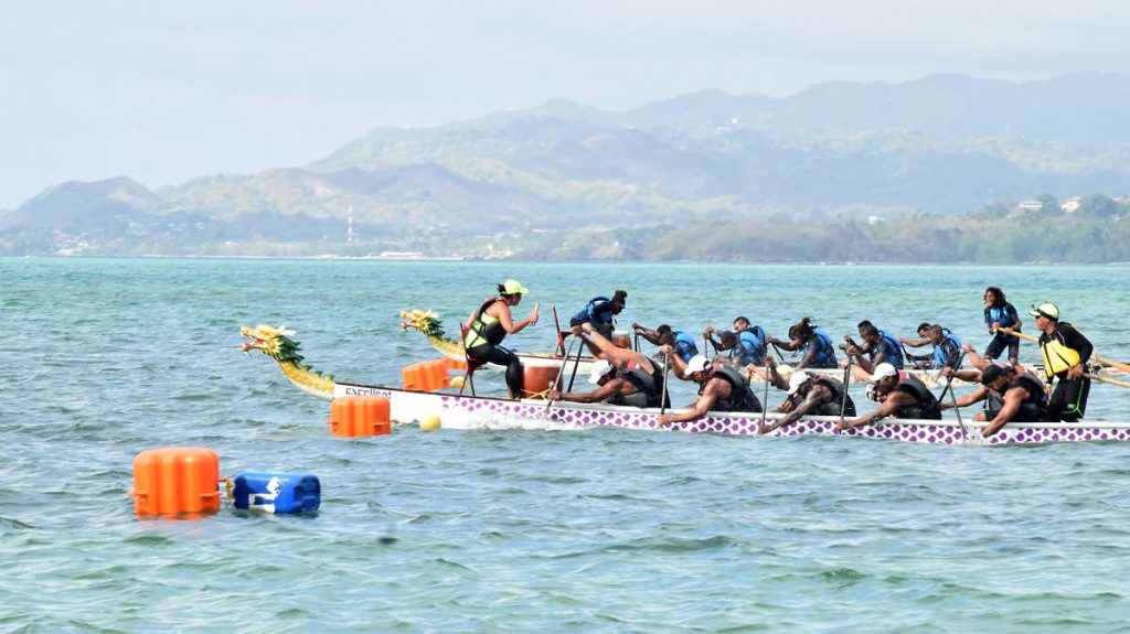 Aquaholics crosses the finish line ahead of Titans in the premier Open 200m race at the Pigeon Point Heritage Park Annual Dragon Boat Festival on Sunday at Pigeon Point Beach.