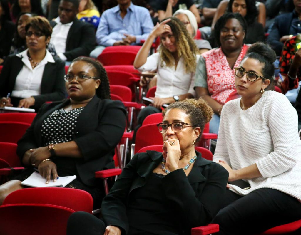 LET'S TALK REFUGEE RIGHTS: Elizabeth Solomon, 2nd from right, coordinator of the UWI Law Faculty International Human Rights Clinic course, listens to a point being made at the symposium. 