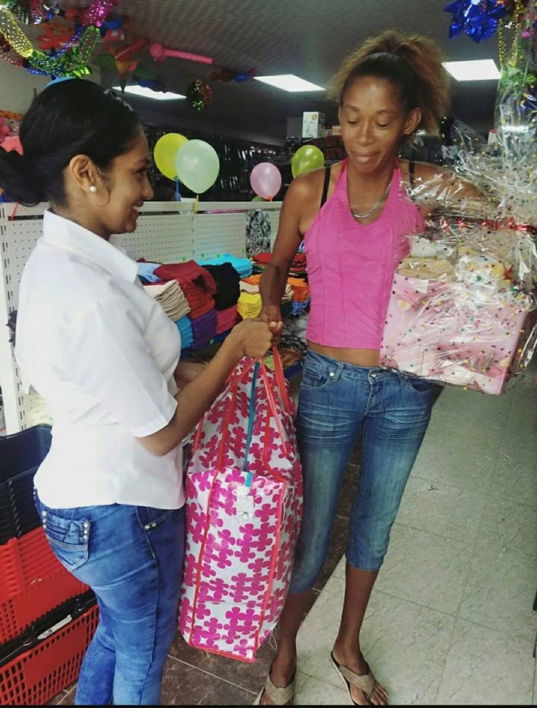 Samantha Persad presents this Guaico, Sangre Grande resident with a hamper of supplies which were donated by the public.