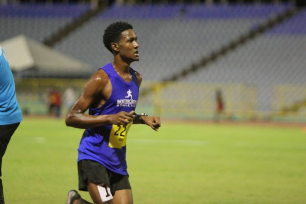 Anthony Phillips competes in the Men’s 10,000m yesterday at the NGC/Sagicor NAAA National Open Championships, at the Hasely Crawford Stadium, Port of Spain. Phillips won gold in the event.