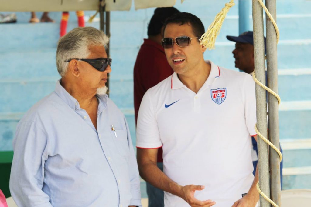 Talking points: Caroni Central MP Dr Bhoe Tewarie and US Deputy Public Affairs Officer Michael Barrera at the launch of a sports caravan hosted by Chaguanas Borough Corporation and the US Embassy in Enterprise yesterday. PHOTO BY LINCOLN HOLDER