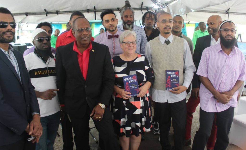 Lessons learnt: Commissioner of Prisons Gerard Wilson, third from left, with Debbie Jacob, centre, and her history students at the launch of her book Making Waves: How the West Indies Shaped the US, at the Port of Spain Prison yesterday. PHOTO BY ENRIQUE ASSOON