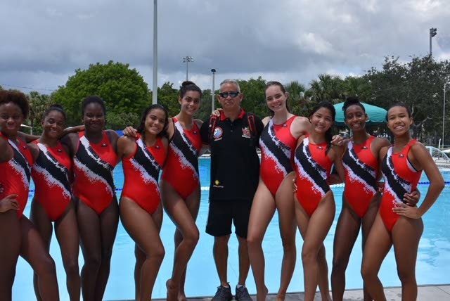 TT’s Under-16 Polo Princesses  waterpolo team poses for a photo during the 2018 Sunshine State Games Water Polo Championships,which takes place this weekend in Coral Springs, Florida, USA. At centre is team coach Alan Too A Foo.