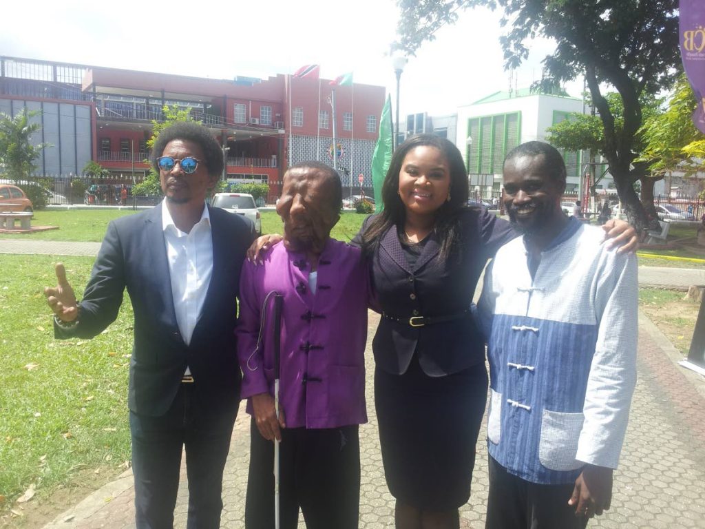 Visually impaired martial arts athlete Shawn Sealy of Barbados, second from left, at the Olympic Day celebrations at Woodford Square, on Friday. Also in the photo are president of the TT Olympic Committee Brian Lewis, left, Minister of Sport and Youth Affairs Shamfa Cudjoe, second from right, and Sealy’s coach Erskine Husbands.