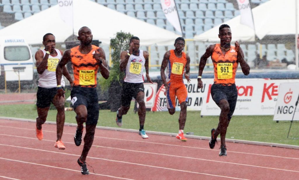 Kyle Greaux, 2nd left, outpaces club mate Jereem Richards,right, to win the Men's 200m final on Sunday, at the NGC/Sagicor/NAAA National Open Championships, held at the Hasely Crawford Stadium, Port of Spain. Photo by Sureash Cholai