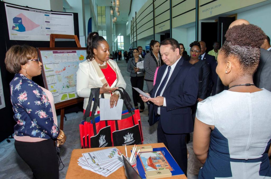 Energy Minister Franklin Khan browses through some of the brochures on display by energy companies at yesterday’s 2018 Energy Resources conference and exhibition at the Hyatt in Port of Spain.