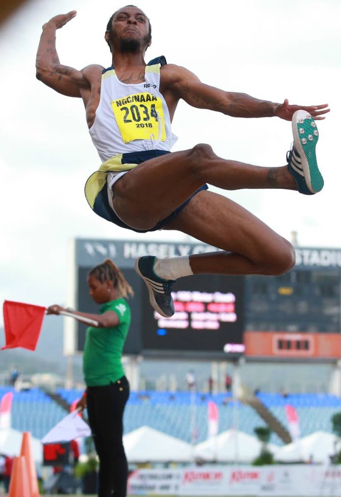 Andwuelle Wright attempts a jump in the men's long jump at the NGC/Sagicor National Open Championships at the Hasely Crawford Stadium, on Saturday. Wright broke the national record with a jump of 8.23m at the event.