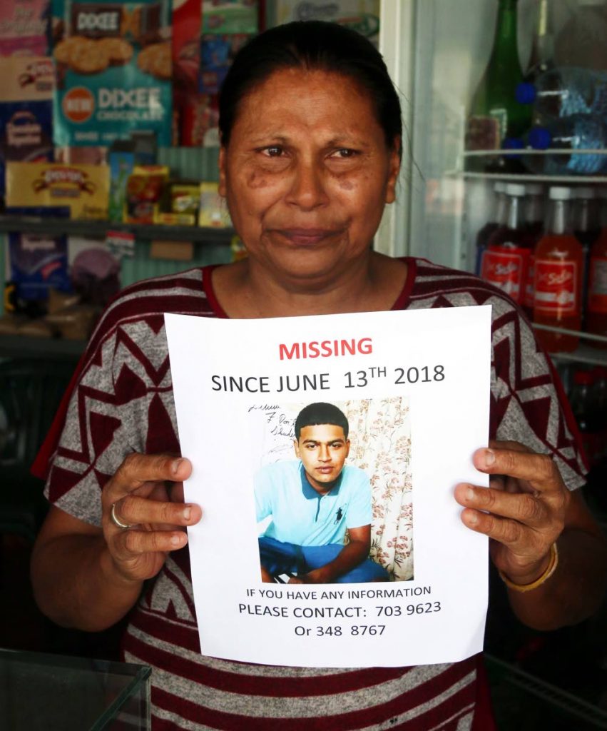 WORRIED MOM: Radica Matagoolam displays a Missing Person poster for her son Anil who has been missing since June 13. PHOTO BY ANSEL JEBODH