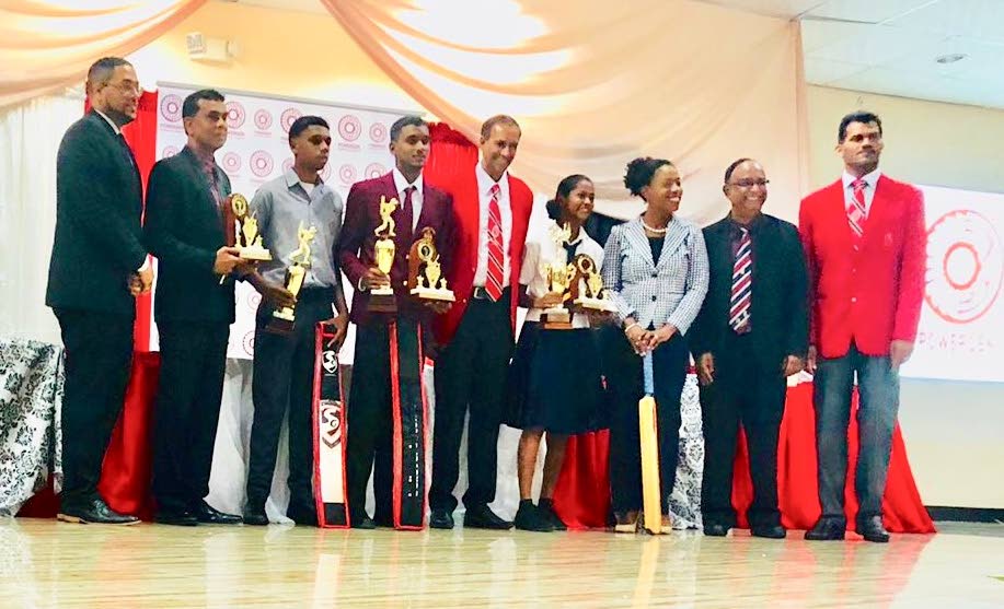 School cricketers of the year Nicholas Ali, third from left, Navin Bidaisee, fourth from left, and Shalini Samaroo, fourth from right. Also in the photo are Francois Ottley of PowerGen, from left, Krishna Rampersad of PowerGen, Surujdath Mahabir of the SSCL, Mignon King of the Ministry of Education, former West Indies manager Omar Khan and Nigel Maraj of the SSCL.