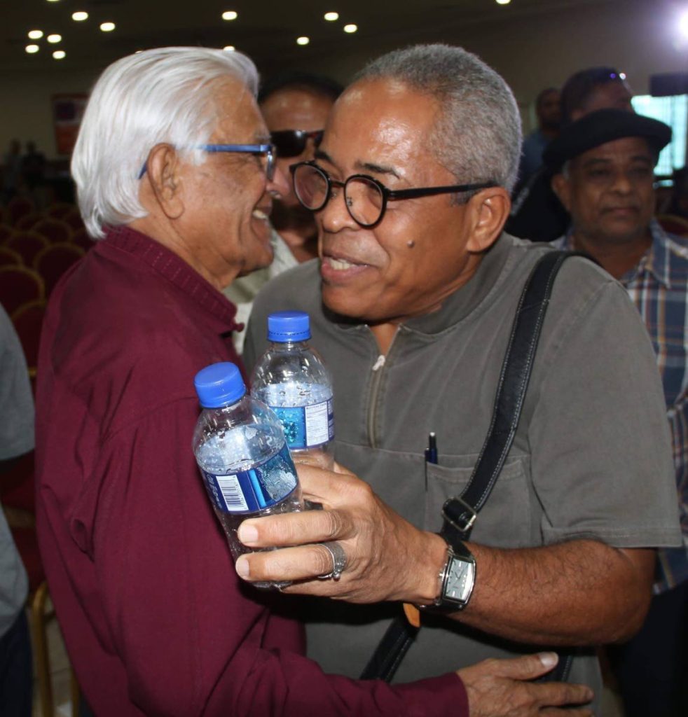 Former Port of Spain Mayor Louis Lee Sing, right, greets former prime minister Basdeo Panday at a recent function.