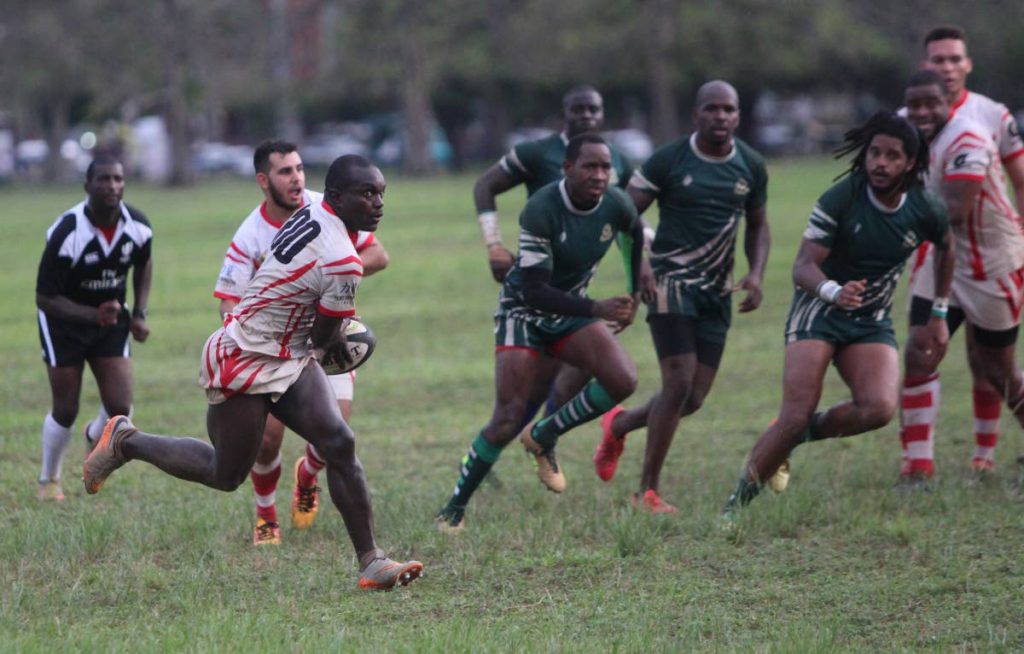 A Caribs player makes a darting run against Harvard yesterday at the Queen's Park Savannah. 