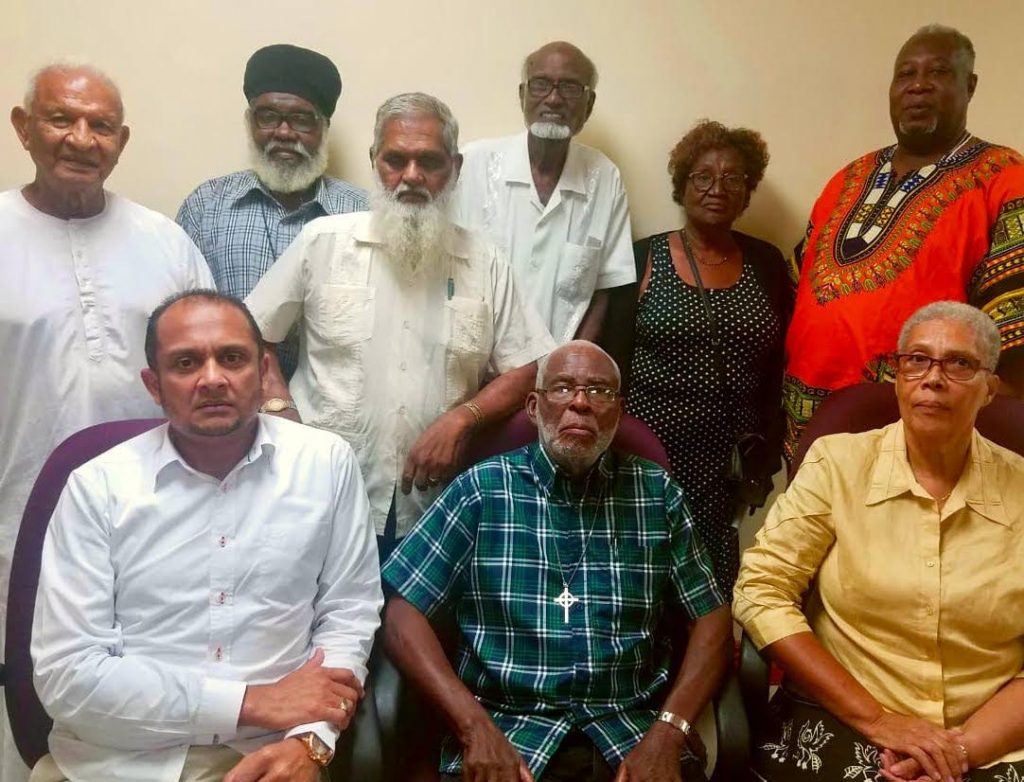 The IRO executive members are, seated left to right, Pundit Lutchmidath Persad Maharaj, Dean Knolly Clarke, president, Mother Joan Irish, back left to right, pundit Bramdeo Maharaj, Brother Hues, Pandit Mukram Sirju, Haji Noble Kahn, Abbess Jermaine Jordan and Baba Neil Ryan Rawlins. 