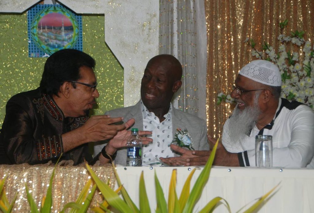 LET’S TALK: Prime Minister Dr Keith Rowley(center) listens to Minister of Rural Development and Local Government Kazim Hosein and Imam Raffic Mohammed at the ASJA’s annual Eid dinner held at Centre Pointe Mall, Chaguanas on Saturday.   PHOTO COURTESY OFFICE OF THE PRIME MINISTER