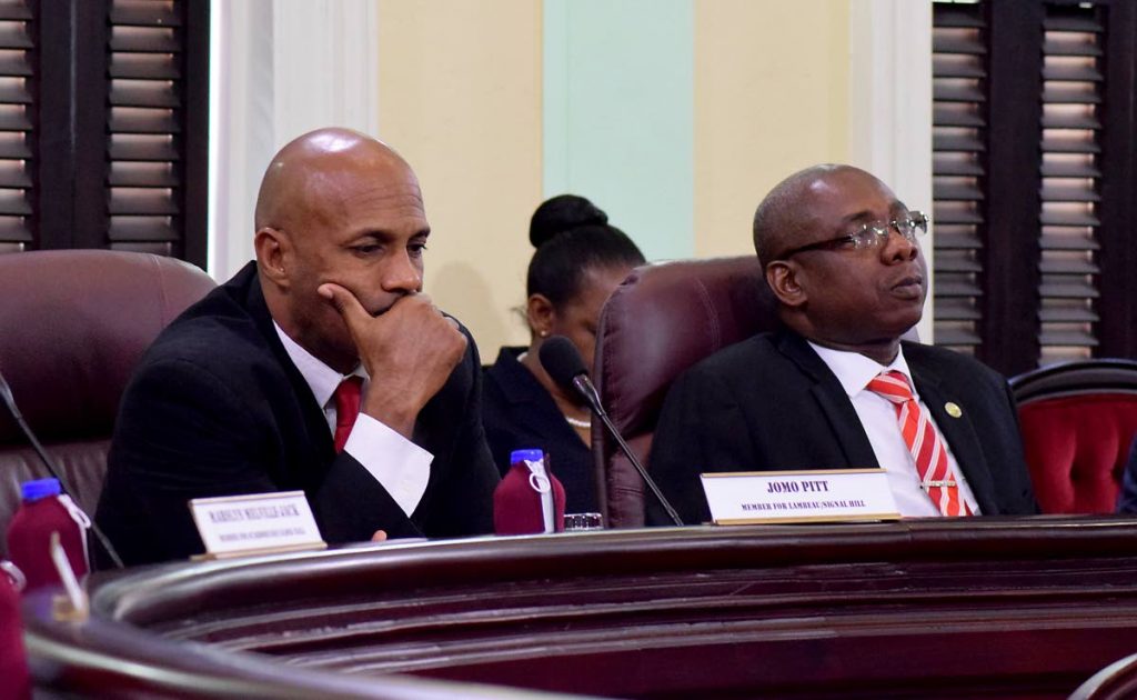 Hayden Spencer, Secretary for the Division of Food and Fisheries, right, listens to debate on the Tobago House of Assembly 2018/2019 budget proposals last Thursday at the Assembly Chamber in Scarborough. At left is Sports Secretary Jomo Pitt.