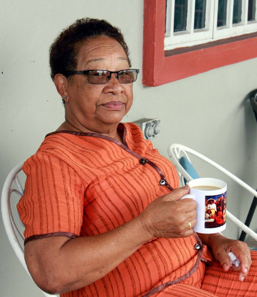 Retired school teacher Cynthia Lee Mack sits with her coffee after a tree fell and damaged part of the roof of her home at Alexander Road in Vistabella on Monday. PHOTO BY ANIL RAMPERSAD