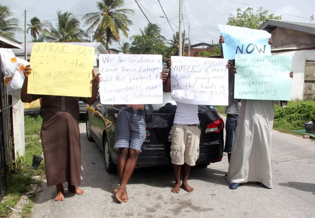 WE WANT JUSTICE: Crown Trace, Enterprise, Chaguanas residents protest last week’s killing, by police, of Keon Moore yesterday.