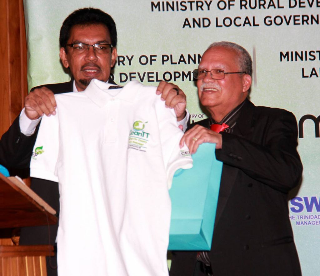 LOOK, IT’S NOT A BRIBE: Local Govt Minister Kazim Hosein, left, displays a CEPEP T-shirt given to him as a gift during the launch of CEPEP’s Clean TT initiative last week in San Fernando. At right is CEPEP chairman Ashton Ford.