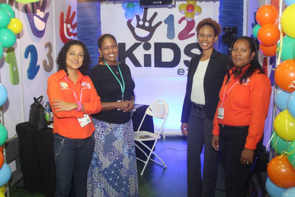 KIDS IN MIND: The 123 Kids Expo booth at the TIC yesterday at the Centre of Excellence in Macoya. From left, Lisa Owen, director at 123 Kids Expo; Allyson McKell-Morales, director of 123 Kids Expo; 
Camille Campbell, booth visitor and Kaisha Lee A Ping-Alfred, CEO of Trendy Trade Show Company and show director of 123 Kids Expo.