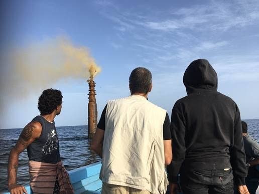 Corporate Secretary of Fisherman and Friends of the Sea (FFOS) Gary Aboud, centre, and other members of the group view the ruptured oil well at sea off Orange valley Fishing Depot in Carapichaima yesterday morning. The abandoned oil well ruptured 6 days ago.