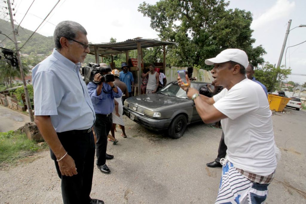FEAR AND
ANGER: Carenage resident Christopher Calder, right, speaks to
Movement for Social Justice (MSJ) leader David Abdulah
yesterday as he called for police to arrest the gunmen who killed three at the
Chaguaramas
boardwalk on Sunday, spreading fear in Carenage communities. PHOTO BY ROGER JACOB