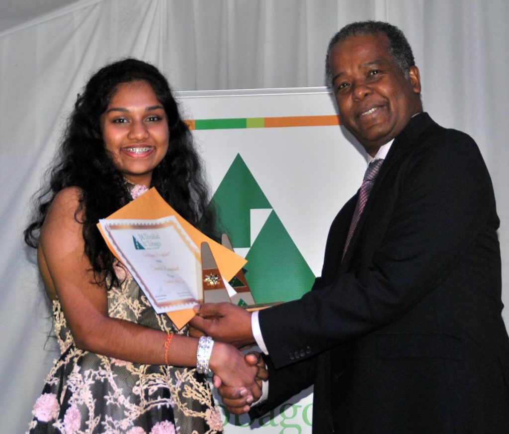Gerard Jackson, head, government and stakeholder relations, BPTT, presents the award for president of the year to Naparima Girls’ Shivala Rampersad, at the Future Unlimited Banquet and  Awards Ceremony at Cascadia Hotel and Conference Centre.