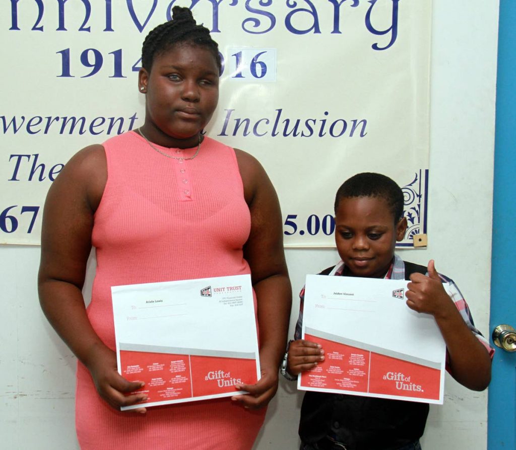 Visually impaired students, left to right, Ariel Lewis and Jaidon Vincent holding certificates for units presented to them by the Unit Trust Corporation after placing in the SEA exams.
PHOTO BY ANIL RAMPERSAD.