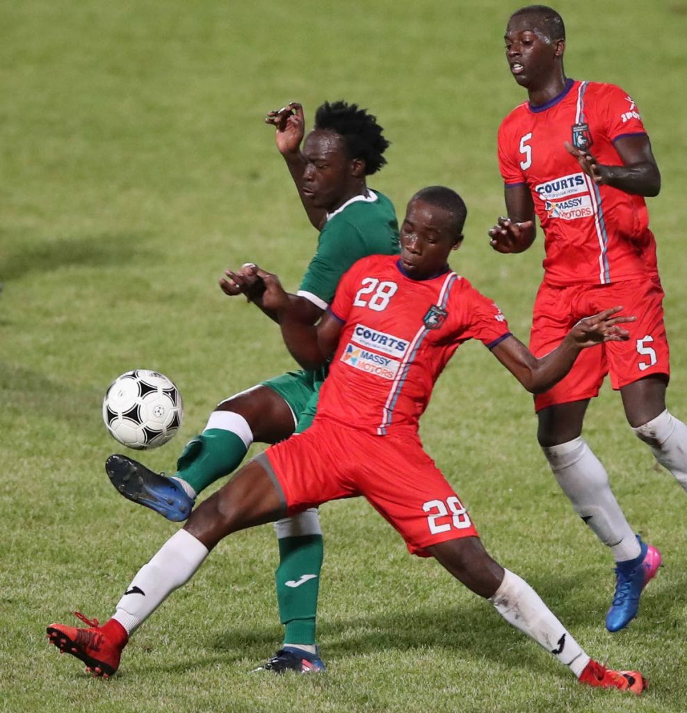 Morvant Caledonia United's Jomokie Cassimy, centre, and Joshua Sylvester, right, mark a W Connection opponent in a First Citizens Cup match at the Ato Boldon Stadium, Couva. 