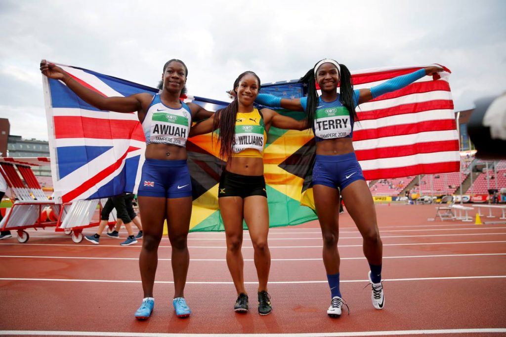 Briana Williams of Jamaica, centre, winner of the women's 100m final at the World Under-20 Championships poses alongside second-placed Twanisha Terry of the US, right, and Great Britian's Kristak Awuah who placed third in Tampere, Finland. 