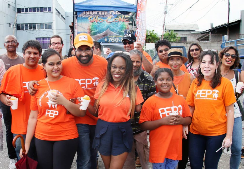 PEP’s Barataria candidate Christoph Samlal (third from left) and Belmont candidate Felicia Holder (centre) are surrounded by supporters during a walkabout in Barataria yesterday.